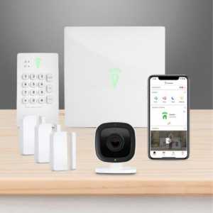 A Frontpoint home security setup that includes a control panel, motion detectors, and a smart camera on a desk.