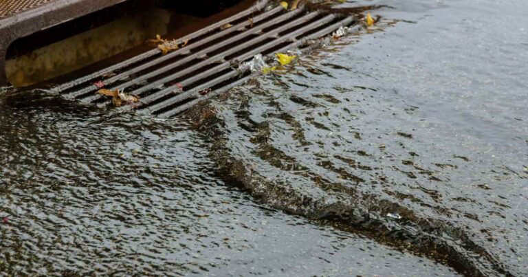 Water gushing from storm sewer following very heavy rainfall