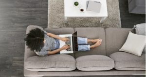 Woman using laptop computer on couch