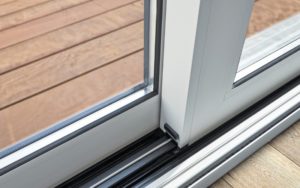 Close-up of a secure lock on a sliding glass door.