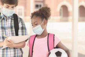 students on school grounds with masks