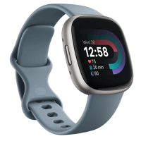 A close-up of the FitBit Versa 4 smartwatch displaying the time and health metrics on its screen.