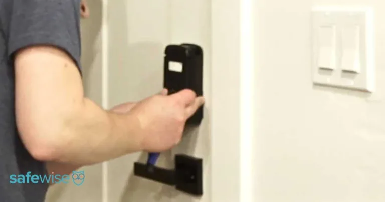 Person installing the Abode smart lock on the inside of a door.