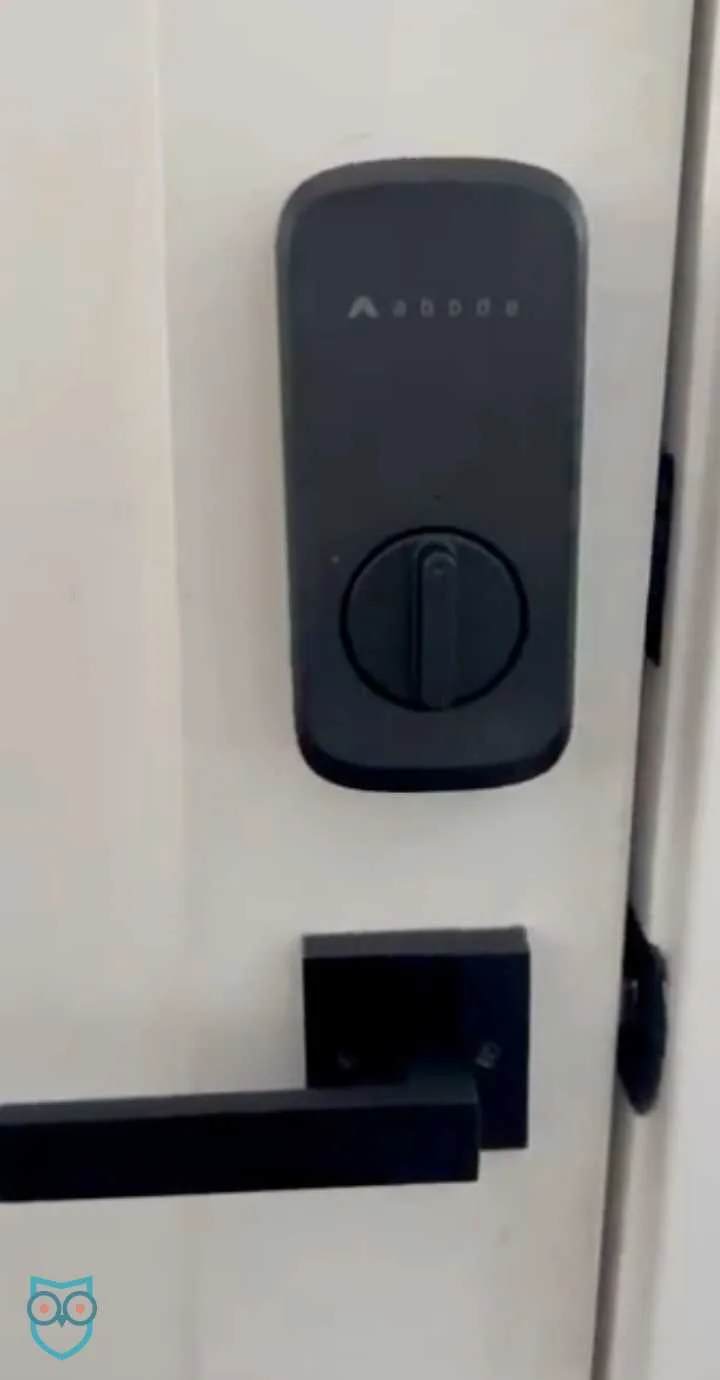 Interior view of the Abode Smart Lock installed on a white door.