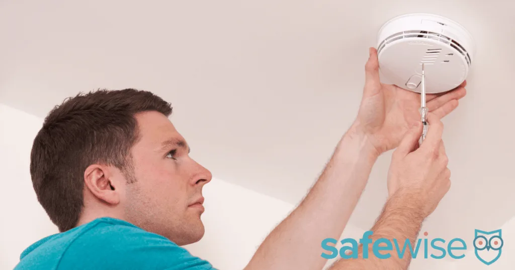 Man installing carbon monoxide detector.