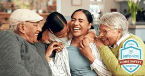 intergenerational family sitting at home together laughing