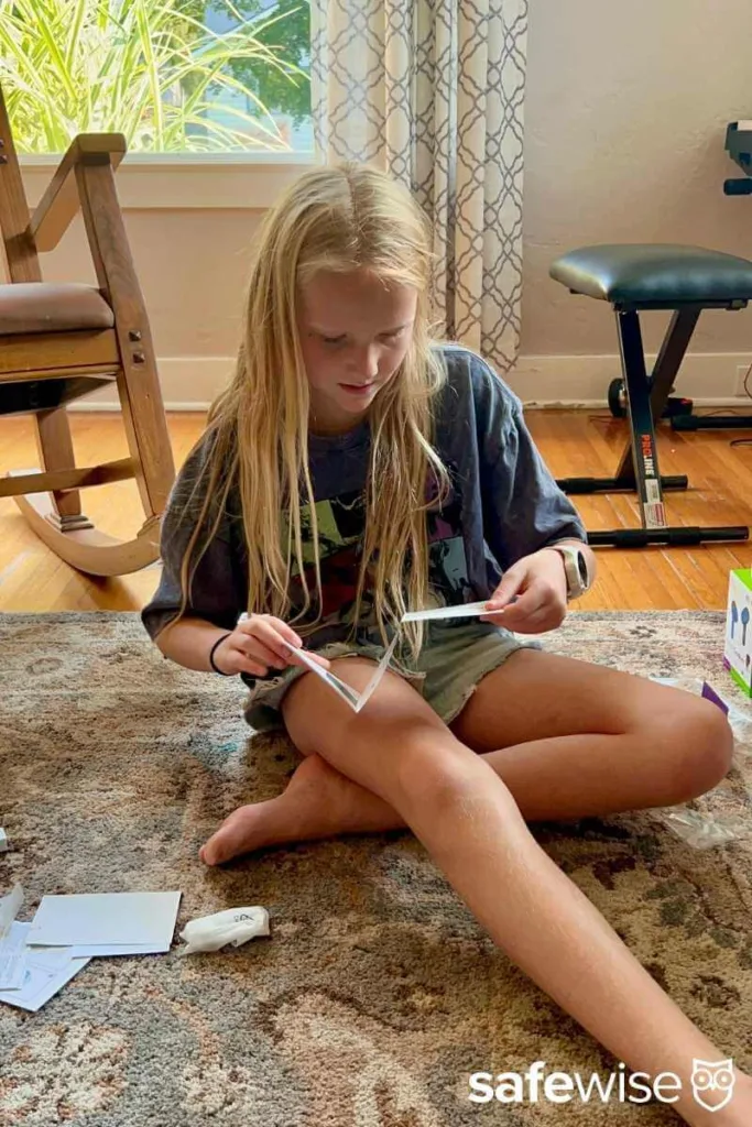 Our kid tester reading the instructions for the myFirst Fone R2 before setting it up.