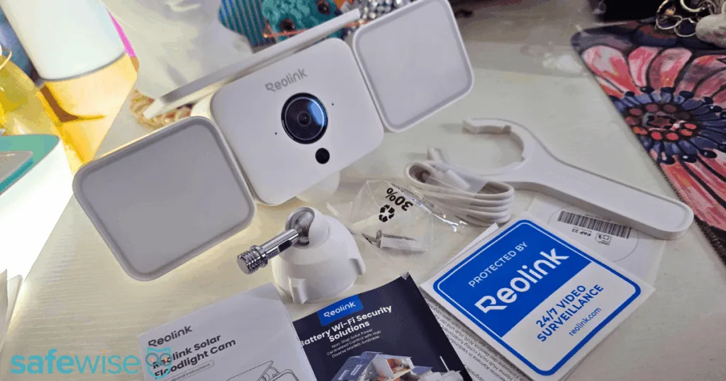 Reolink Solar Floodlight Cam surrounded by what comes in the box.