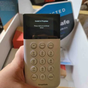 Front view of a SimpliSafe home security system keypad held by a SafeWise tester.